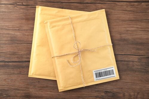 Gift padded envelopes on wooden table